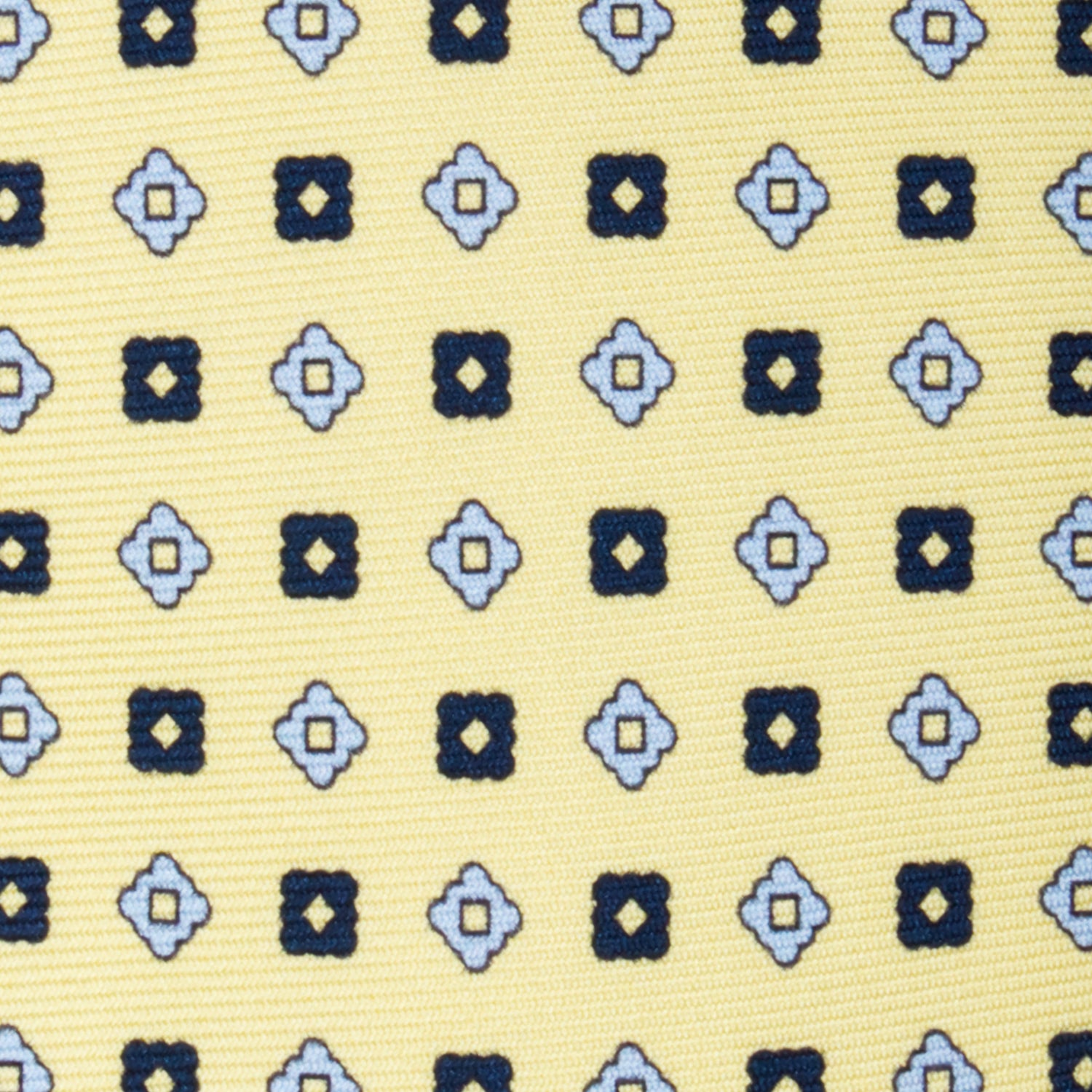 CORBATA 7 PLIEGUES EN SEDA CON ROMBOS AZUL OBSCURO Y FLORES AZULES EN AMARILLO LIMÓN