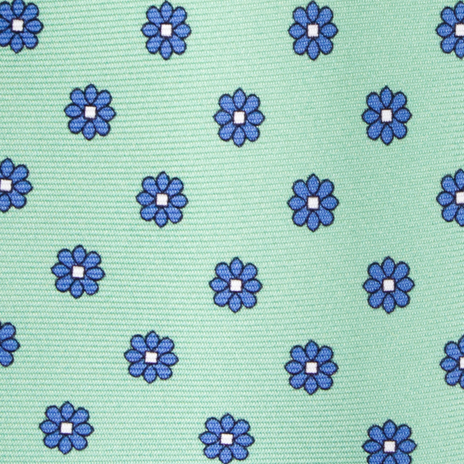 CORBATA 7 PLIEGUES EN SEDA CON FLORES AZULES CON PUNTOS BLANCOS EN VERDE