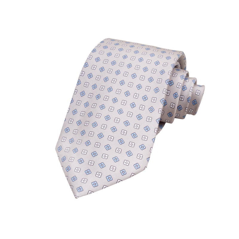 CORBATA 7 PLIEGUES EN SEDA CON ROMBOS AZULES Y FLORES BLANCAS EN GRIS