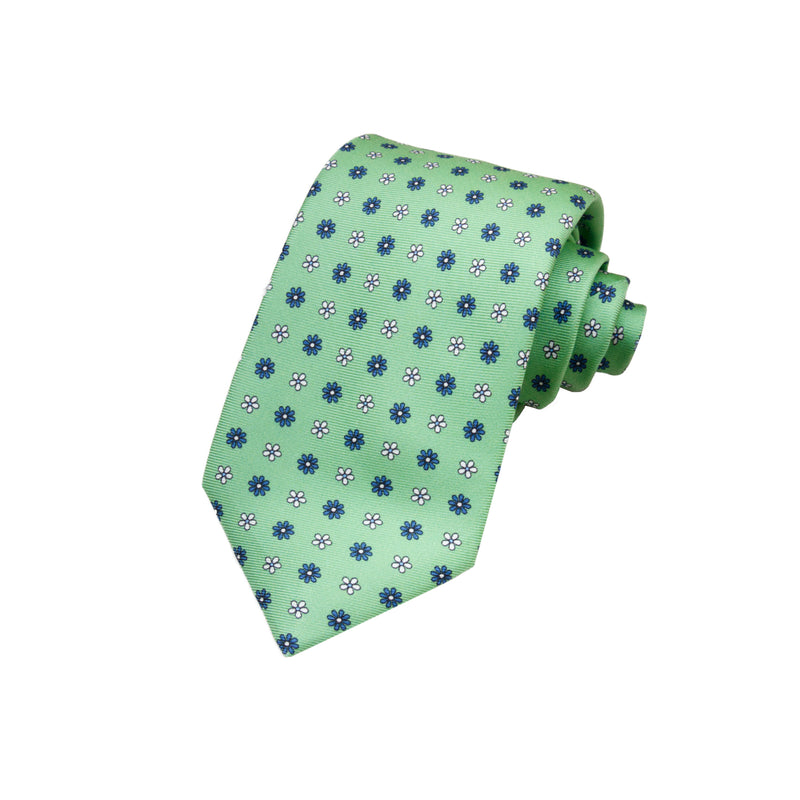 CORBATA 7 PLIEGUES EN SEDA WOOVEN CON FLORES EN BLANCO Y AZUL EN VERDE