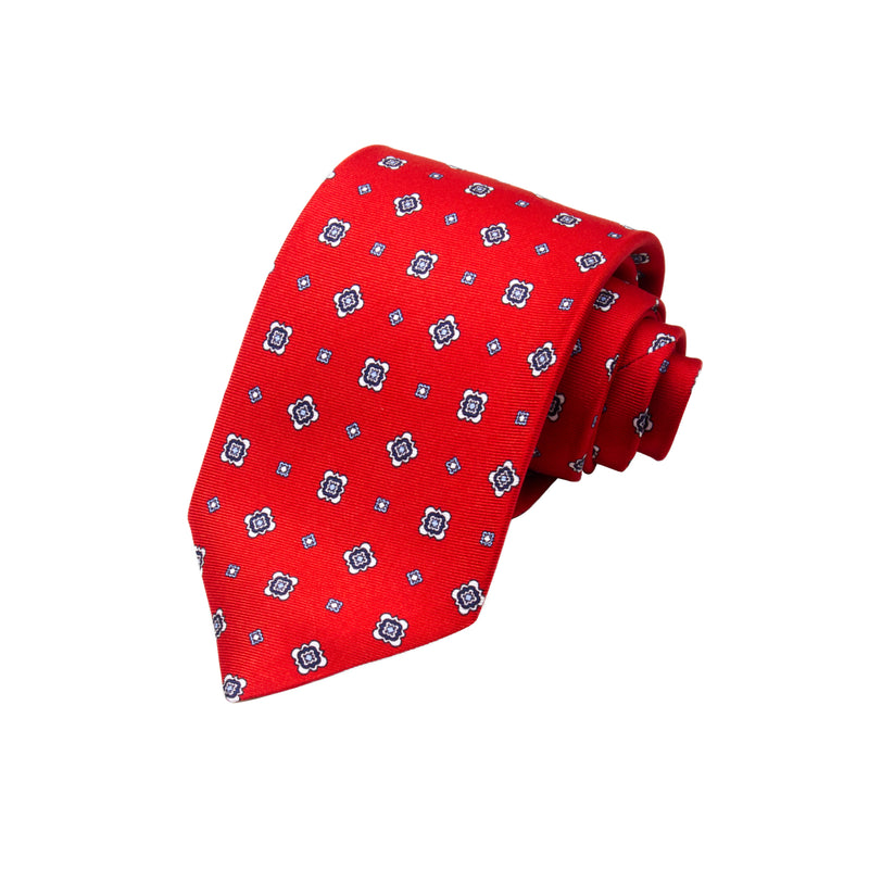 CORBATA 7 PLIEGUES EN SEDA CON FLORES BLANCAS, AZULES Y PUNTOS AZULES EN ROJO