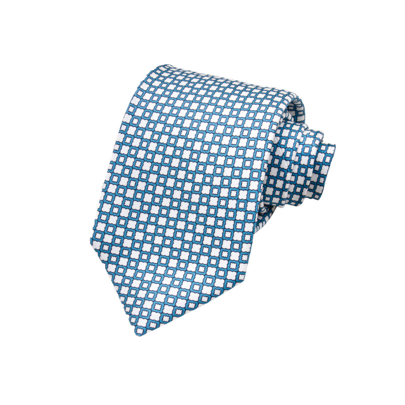 CORBATA 7 PLIEGUES EN SEDA WOOVEN CON PUNTOS Y FLORES BLANCAS EN AZUL